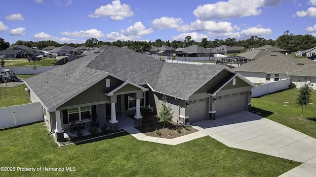 12848 Hilary St, Spring Hill, FL 34609 - view of front of home featuring a shingled roof, a garage, a residential view, and a fenced backyard