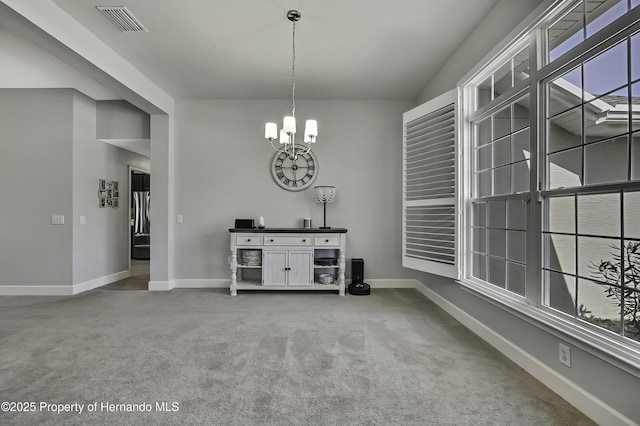 12848 Hilary St, Spring Hill, FL 34609 - dining space with visible vents, baseboards, carpet flooring, and an inviting chandelier