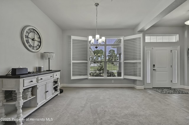 12848 Hilary St, Spring Hill, FL 34609 - carpeted dining area featuring a wealth of natural light, a notable chandelier, and baseboards
