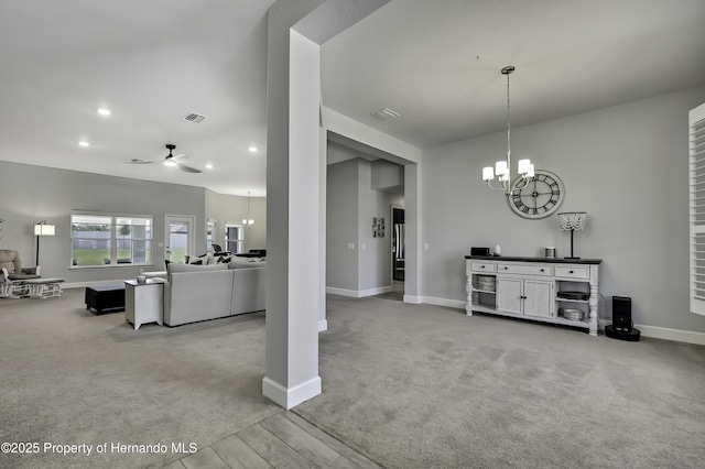 12848 Hilary St, Spring Hill, FL 34609 - dining space featuring visible vents, baseboards, recessed lighting, ceiling fan with notable chandelier, and light carpet