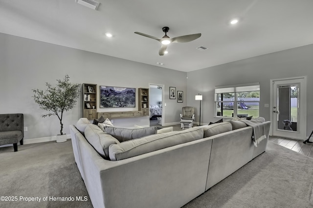 12848 Hilary St, Spring Hill, FL 34609 - carpeted living room with visible vents, ceiling fan, and recessed lighting