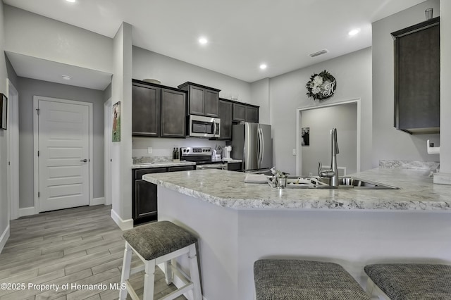 12848 Hilary St, Spring Hill, FL 34609 - kitchen featuring a peninsula, light countertops, visible vents, stainless steel appliances, and a sink