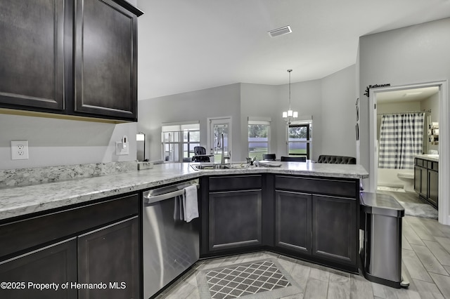 12848 Hilary St, Spring Hill, FL 34609 - kitchen featuring a peninsula, light stone countertops, visible vents, stainless steel dishwasher, and a sink
