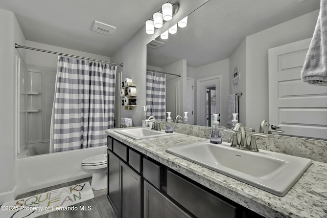 12848 Hilary St, Spring Hill, FL 34609 - bathroom with shower / bath combo, double vanity, a sink, and toilet
