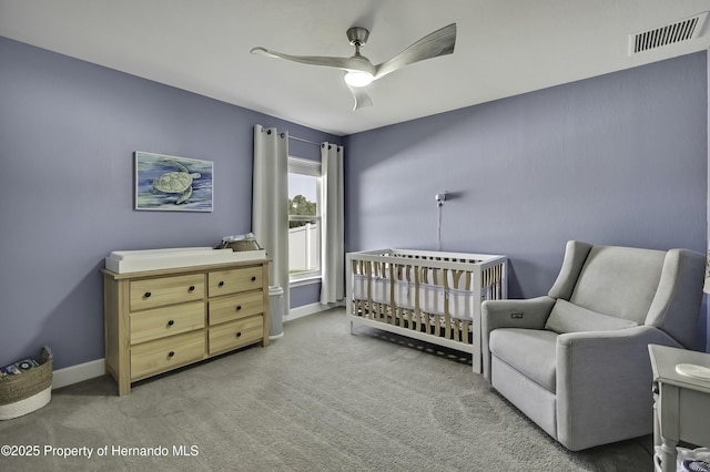 12848 Hilary St, Spring Hill, FL 34609 - carpeted bedroom featuring baseboards, a ceiling fan, visible vents, and a nursery area