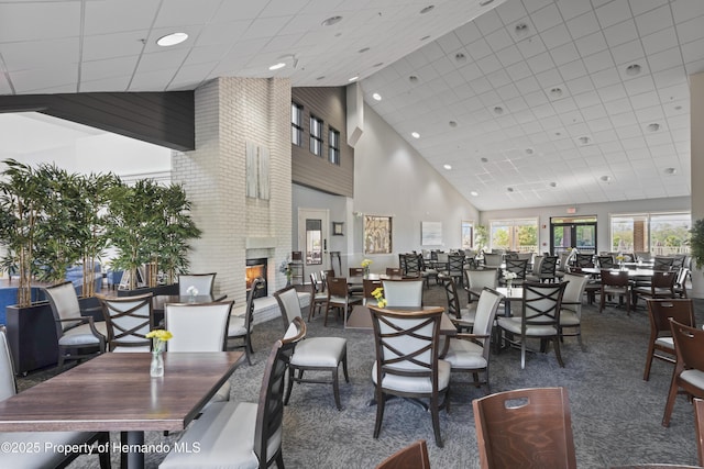 11250 Hollander Ave, Hudson, FL 34667 - dining room with recessed lighting, carpet flooring, a brick fireplace, and high vaulted ceiling