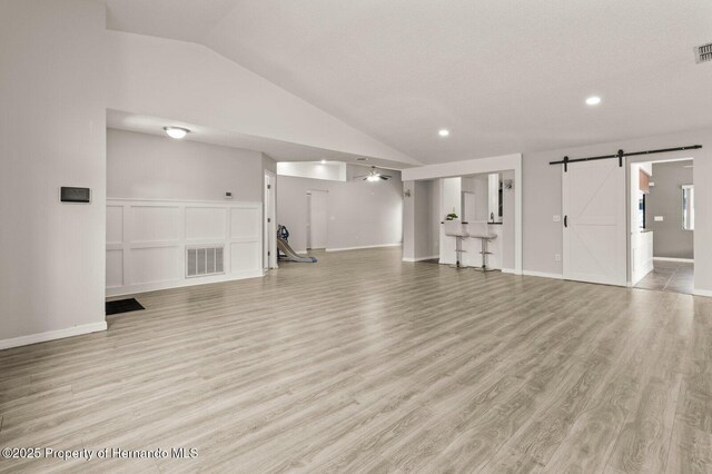 4405 Plumosa St, Spring Hill, FL 34607 - basement with a barn door, light wood finished floors, visible vents, and recessed lighting