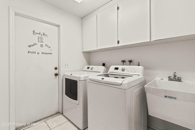 4405 Plumosa St, Spring Hill, FL 34607 - washroom featuring cabinet space, a textured ceiling, separate washer and dryer, and a sink
