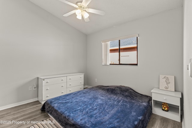 4405 Plumosa St, Spring Hill, FL 34607 - bedroom featuring vaulted ceiling, wood finished floors, a ceiling fan, and baseboards