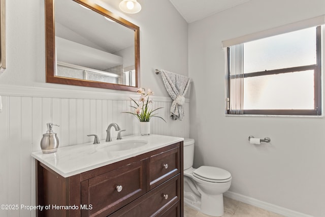 4405 Plumosa St, Spring Hill, FL 34607 - bathroom with a wainscoted wall, vanity, tile patterned flooring, and toilet