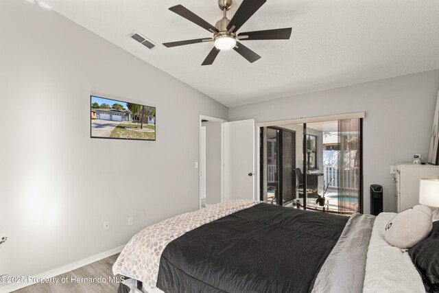 4405 Plumosa St, Spring Hill, FL 34607 - bedroom featuring light wood-style flooring, baseboards, lofted ceiling, access to exterior, and visible vents