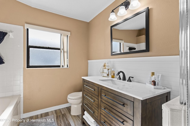 4405 Plumosa St, Spring Hill, FL 34607 - full bathroom featuring wood finished floors, toilet, vanity, a bathtub, and walk in shower