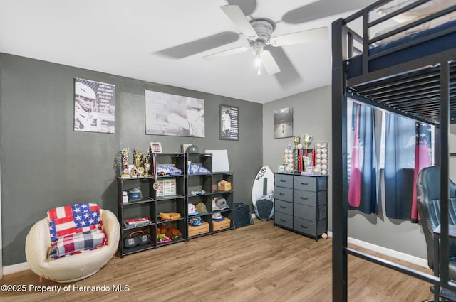 bedroom with wood finished floors and a ceiling fan