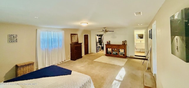bedroom with baseboards, ensuite bath, visible vents, and light colored carpet