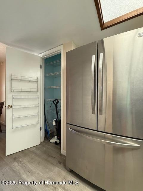 947 Village Dr, Brooksville, FL 34601 - detailed view of freestanding refrigerator and wood finished floors