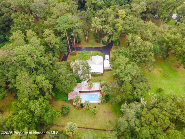 drone / aerial view featuring a view of trees