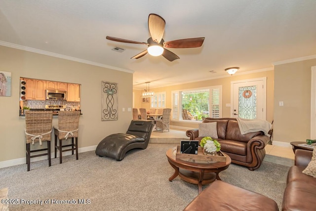 living area featuring ceiling fan with notable chandelier, baseboards, visible vents, and crown molding