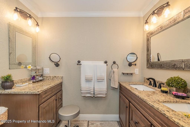 bathroom with double vanity, baseboards, a sink, and ornamental molding