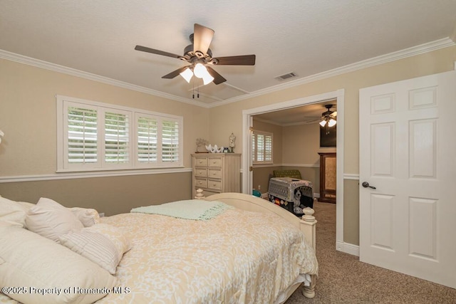 bedroom featuring crown molding, visible vents, carpet flooring, and a ceiling fan