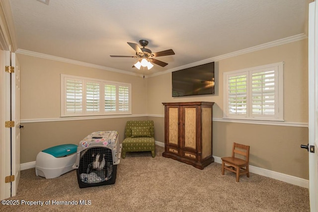 sitting room featuring plenty of natural light, carpet flooring, ceiling fan, and crown molding