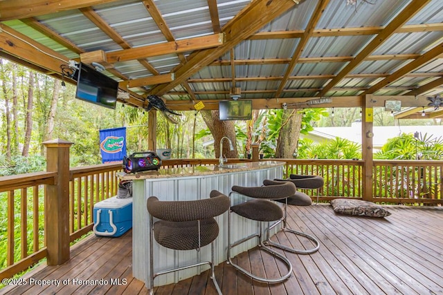wooden deck featuring outdoor dry bar and a sink