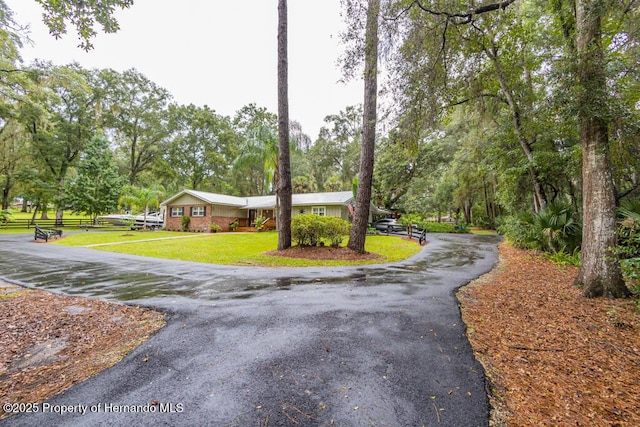 view of front of home with a front lawn and aphalt driveway