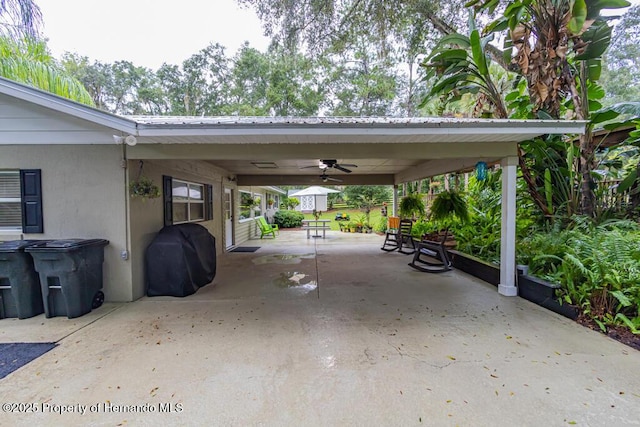 exterior space with ceiling fan, a carport, and concrete driveway