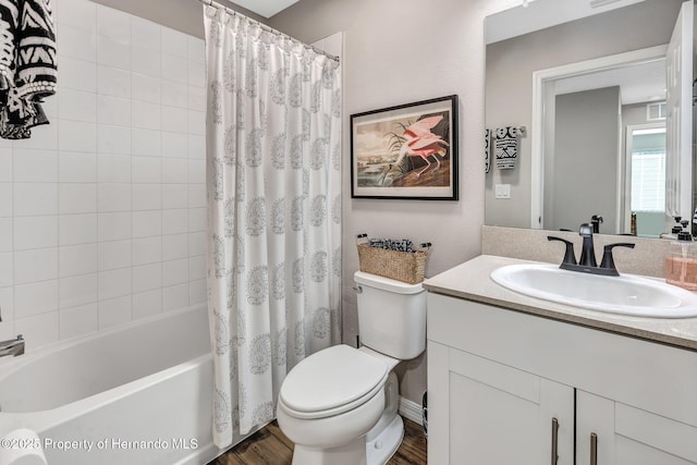 bathroom featuring shower / bath combo, wood finished floors, toilet, and vanity