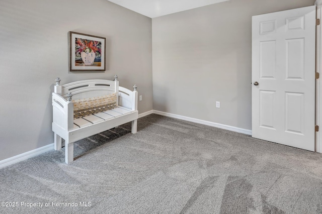 carpeted bedroom featuring baseboards