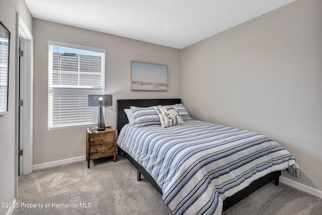 carpeted bedroom with baseboards