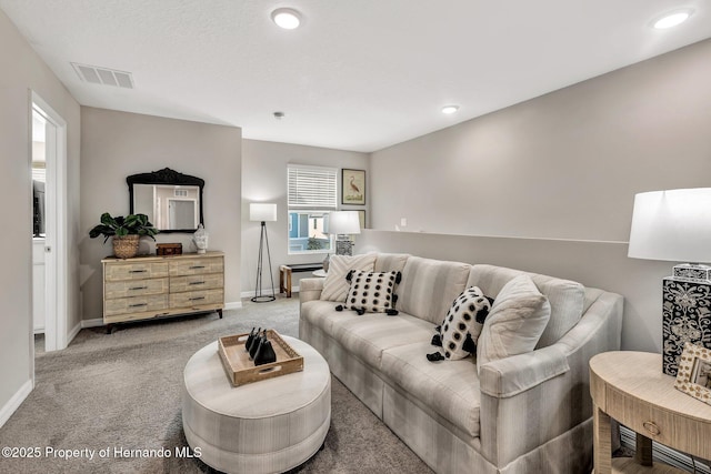 living area featuring recessed lighting, visible vents, light colored carpet, and baseboards