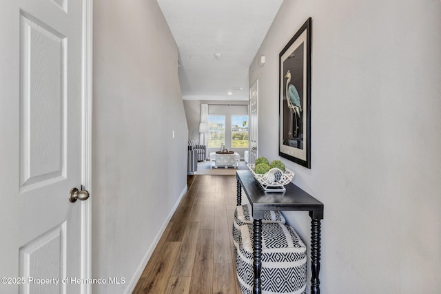 hall featuring dark wood finished floors and baseboards