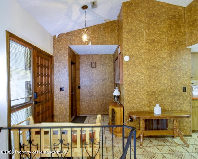 interior space featuring visible vents and lofted ceiling