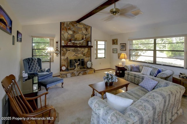 living room with carpet flooring, a ceiling fan, plenty of natural light, and vaulted ceiling with beams