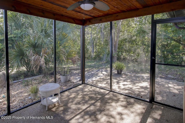 unfurnished sunroom with a ceiling fan