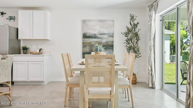dining area with baseboards, a wealth of natural light, and light tile patterned flooring