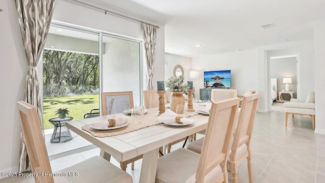 dining area featuring light tile patterned flooring and visible vents