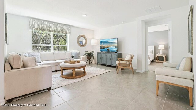living room featuring visible vents and light tile patterned flooring