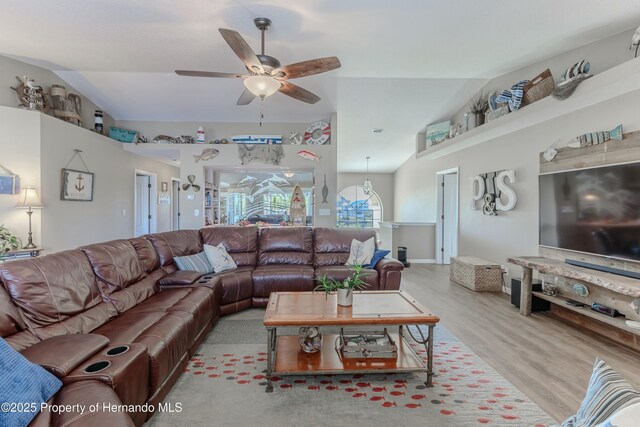 4285 Flexer Dr, Hernando Beach, FL 34607 - living room with lofted ceiling, wood finished floors, and a ceiling fan