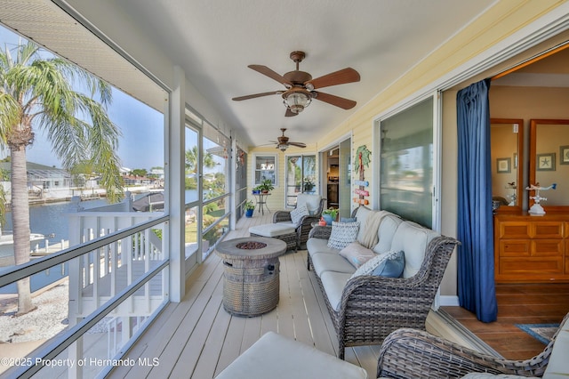 4285 Flexer Dr, Hernando Beach, FL 34607 - sunroom featuring an outdoor living space, a ceiling fan, and a water view