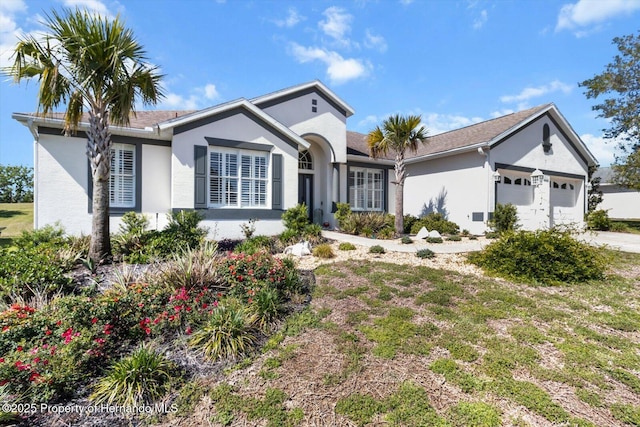 262 W Romany Loop, Beverly Hills, FL 34465 - view of front of home with a garage, concrete driveway, and stucco siding