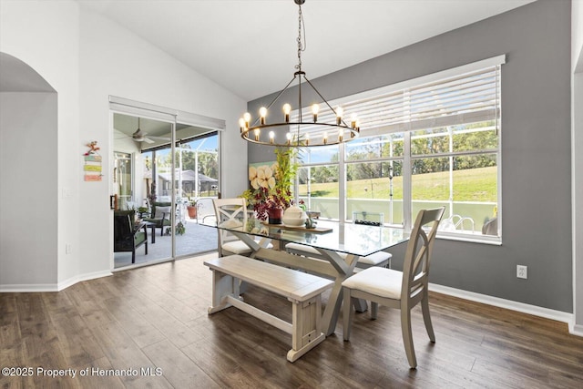 262 W Romany Loop, Beverly Hills, FL 34465 - dining space featuring ceiling fan with notable chandelier, arched walkways, dark wood-type flooring, and baseboards
