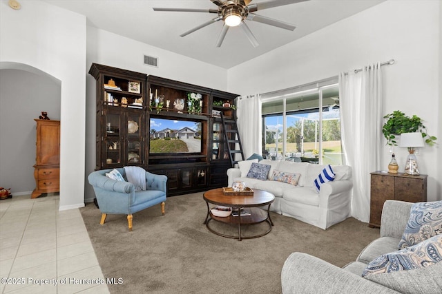 262 W Romany Loop, Beverly Hills, FL 34465 - carpeted living area with tile patterned floors, visible vents, arched walkways, baseboards, and ceiling fan