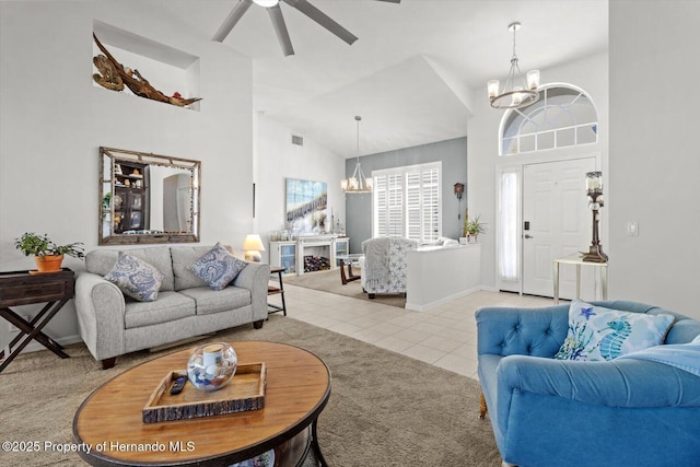 262 W Romany Loop, Beverly Hills, FL 34465 - living area with high vaulted ceiling, ceiling fan with notable chandelier, light tile patterned flooring, light colored carpet, and visible vents