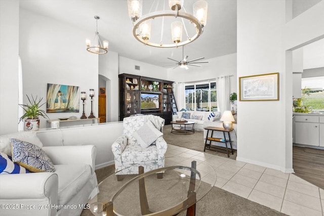 262 W Romany Loop, Beverly Hills, FL 34465 - living room with tile patterned flooring, baseboards, a wealth of natural light, and ceiling fan with notable chandelier