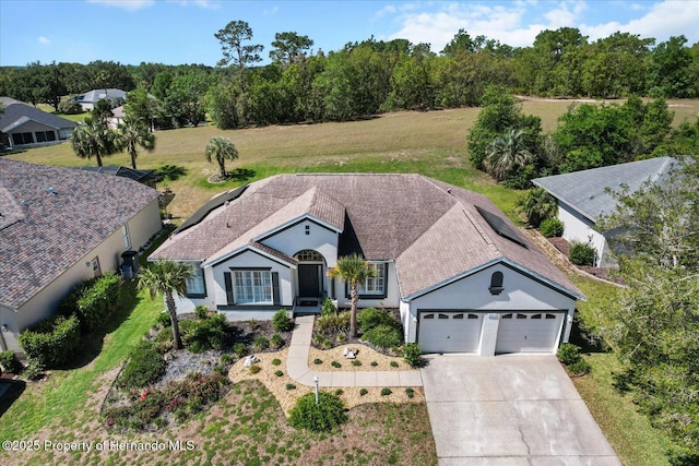 262 W Romany Loop, Beverly Hills, FL 34465 - ranch-style home with stucco siding, an attached garage, and concrete driveway
