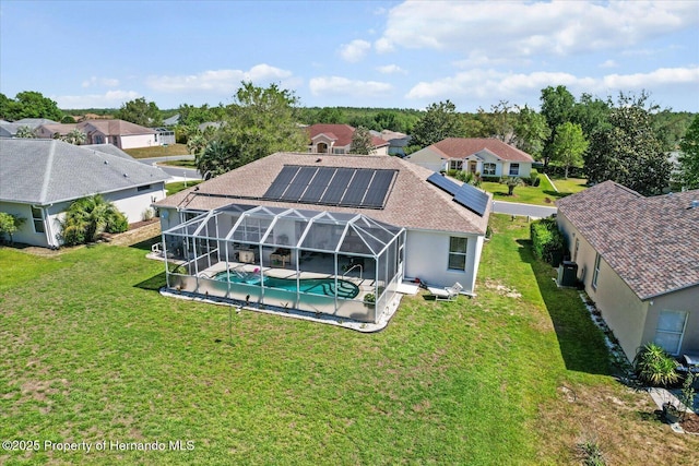 262 W Romany Loop, Beverly Hills, FL 34465 - rear view of house with a residential view, an outdoor pool, a lawn, roof mounted solar panels, and a patio