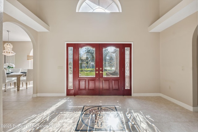 4469 Lake In The Woods Dr, Weeki Wachee, FL 34607 - entryway with a towering ceiling, arched walkways, and baseboards
