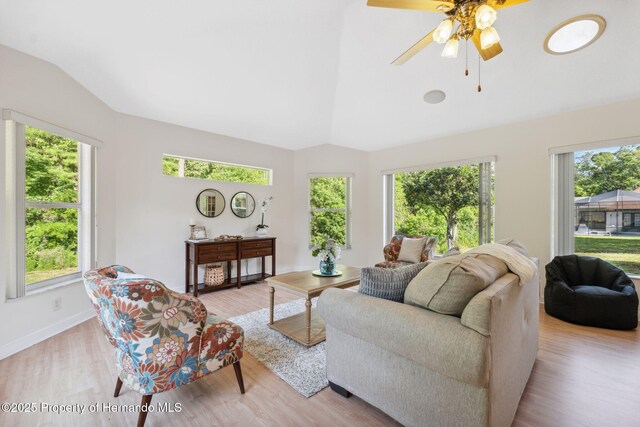 4469 Lake In The Woods Dr, Weeki Wachee, FL 34607 - living area with light wood-type flooring, a healthy amount of sunlight, and vaulted ceiling