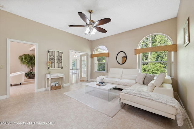 4469 Lake In The Woods Dr, Weeki Wachee, FL 34607 - living area featuring a ceiling fan, tile patterned floors, and baseboards